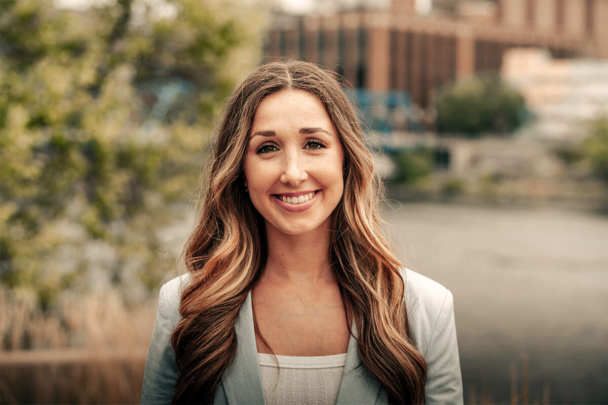 Wellness coach smiling outdoors in soft natural light