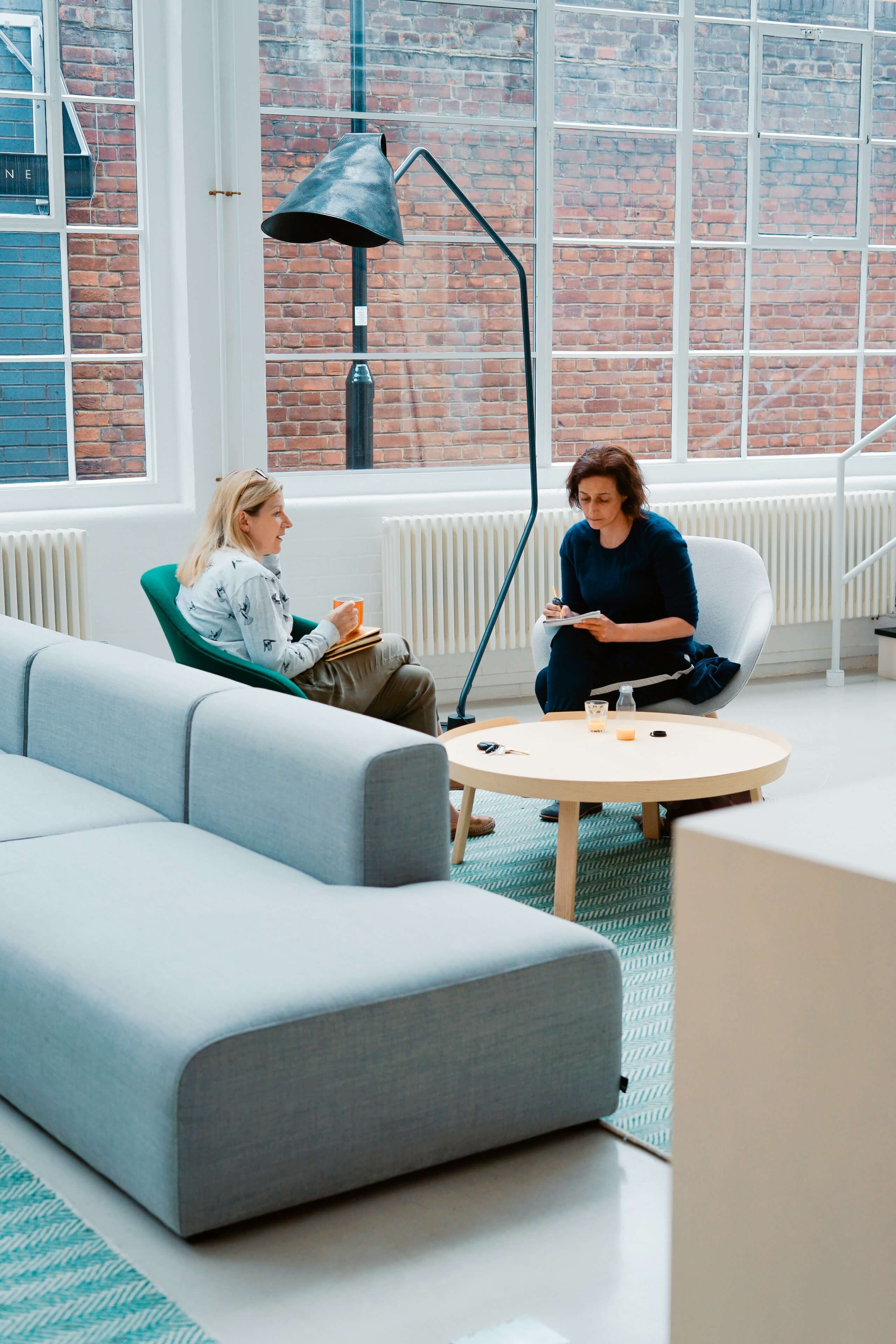 Supportive one-on-one coaching conversation in a calm, welcoming space